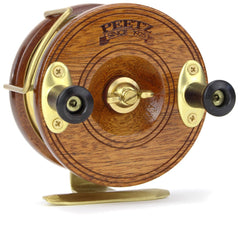Lot - A wood and brass N. Lupkoski fishing reel. 6 in.